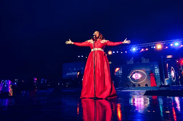 Singer performing on a blue lit stage from Cosmic Media’s gallery